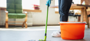 Mopping the floor near a bucket in San Mateo County.