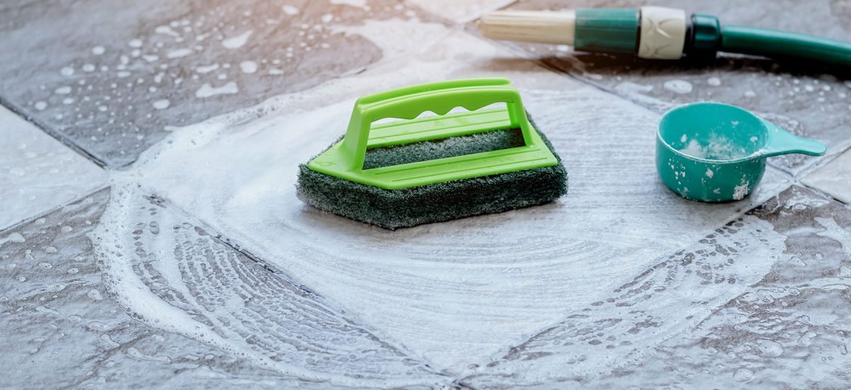 Office cleaning tools with soapy water on tiled surface in San Mateo County.